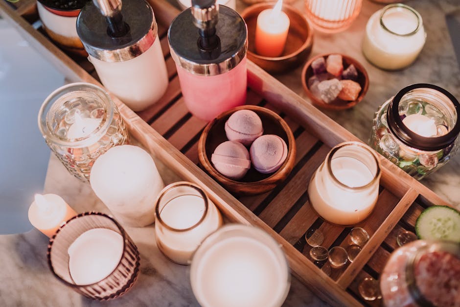 A cozy spa scene featuring candles, lotion, and essential oils for a relaxing atmosphere