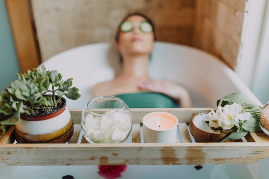 Woman relaxing in a bathtub with a candle and plants, enjoying a serene spa experience